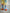 Back view of kids socks in yellow and blue diamond knit design with orange ankle, heel, and toe details, Clean Plate Club logos on both ankles, paired with Brrr yellow sweatpants