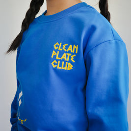 Close-up of Clean Plate Club embroidery on Brrr kids sweatshirt, highlighting chain-stitched text and food-inspired motifs. Designed in a cotton-polyester blend for comfort, this sweatshirt combines playful details with practical wearability for children.