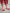 Kids corn dog striped socks with vertical red and white knit stripes, green ankle cuff, and corn dog graphic with Brrr logo-shaped ketchup detail, styled with rose corduroy pants