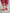 Back view of kids socks featuring red and white knit stripes with green ankle cuff and corn dog design with Brrr ketchup logo, paired with rolled-up corduroy pants