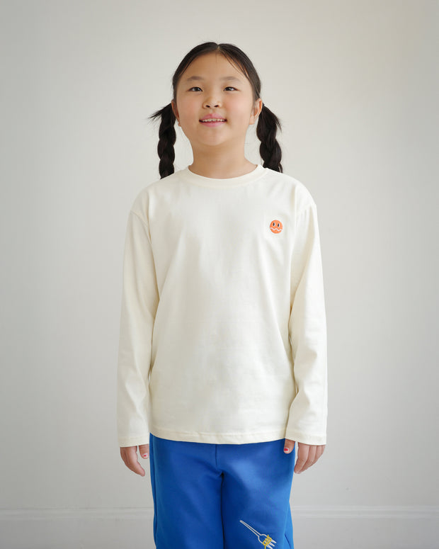Front view of kids ivory cotton long sleeve t-shirt with embroidered Brrr logo on chest