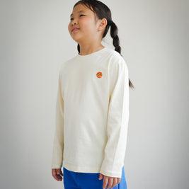 Side view of children’s ivory long sleeve shirt featuring embroidered Brrr logo detail
