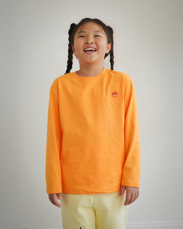 Front view of kids orange cotton long sleeve t-shirt with embroidered Brrr logo