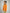 Side view of children’s orange long sleeve shirt with embroidered Brrr logo on chest