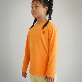 Side view of children’s orange long sleeve shirt with embroidered Brrr logo on chest