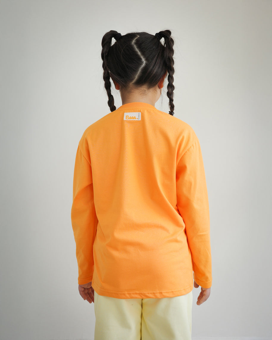 Back view of kids orange cotton long sleeve t-shirt featuring Brrr main label on the outside back neck