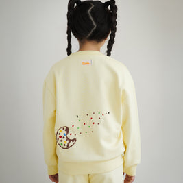 Back view of kids yellow sweatshirt by Brrr, featuring additional cookie crumb and ant chain embroidery along with playful food-inspired details. The sweatshirt combines comfort with whimsical design, reflecting the Sweet Tooth Club theme.